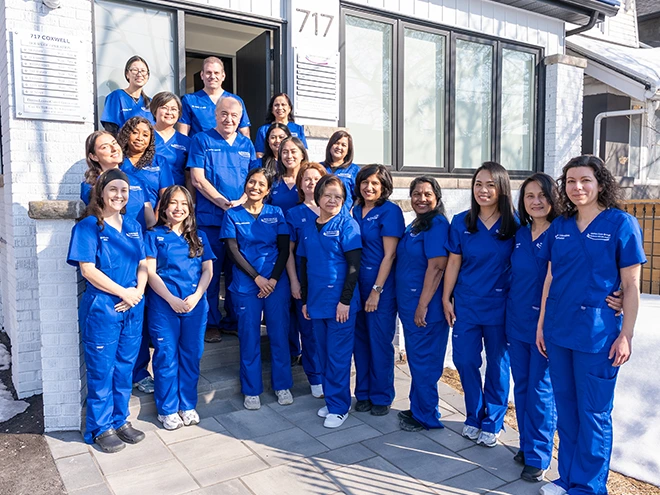 Dental team standing together outside the clinic.