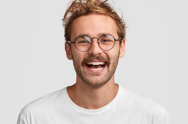 Smiling man showing healthy white teeth.