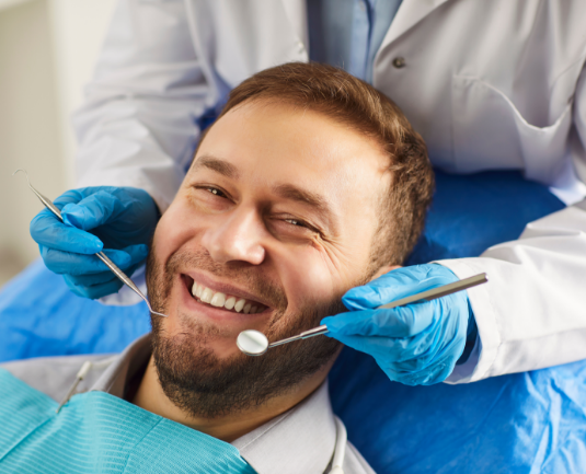 Smiling patient during a dental examination.
